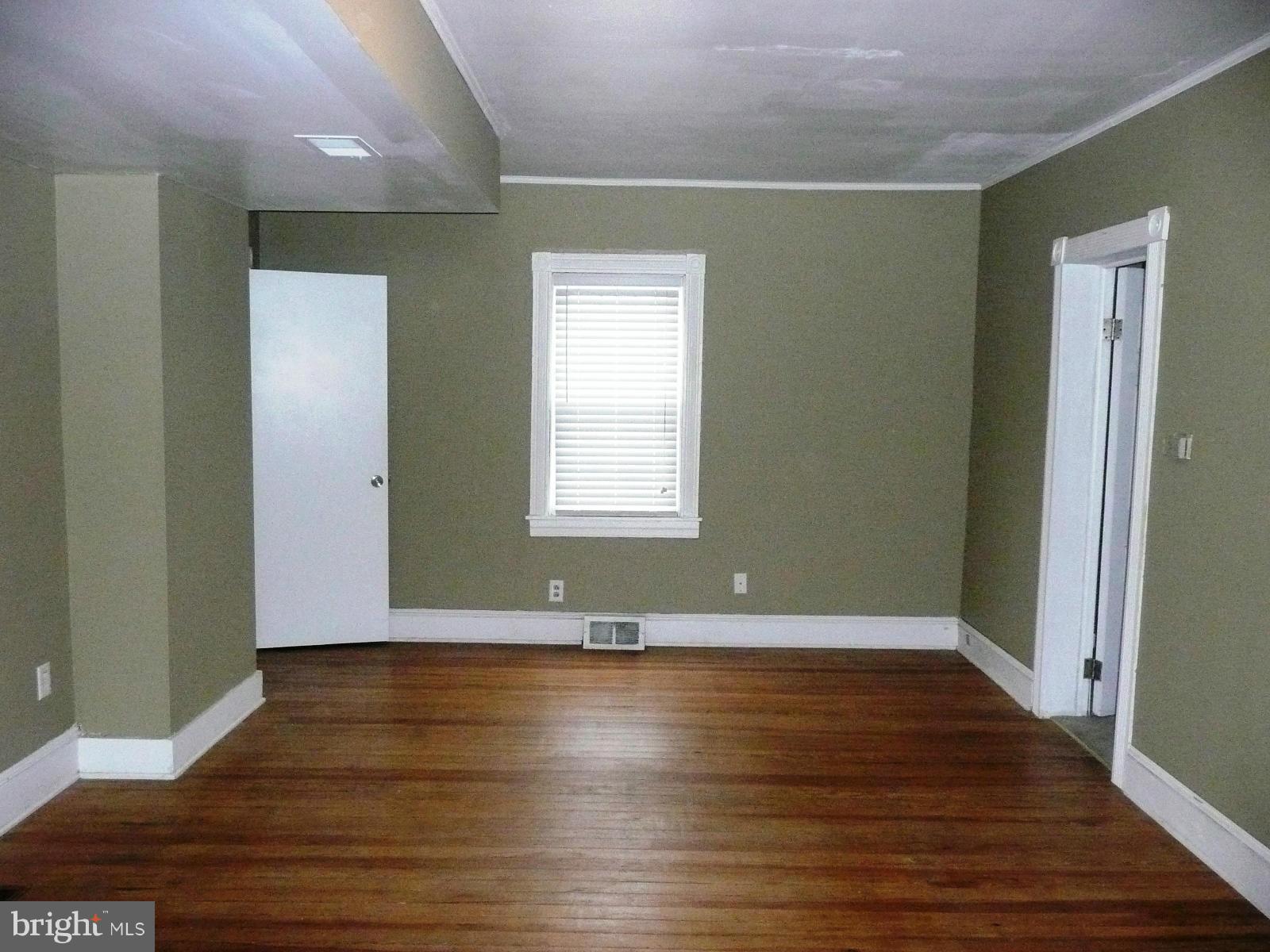 501 South Mildred Street Ranson, WV 25438 - Photo 7 of 29 an empty room with wooden floor and windows