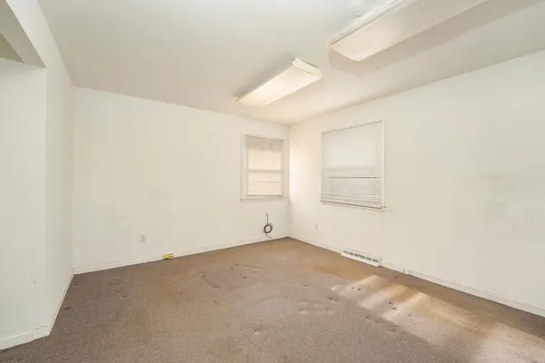 a view of a room with a window and ceiling fan