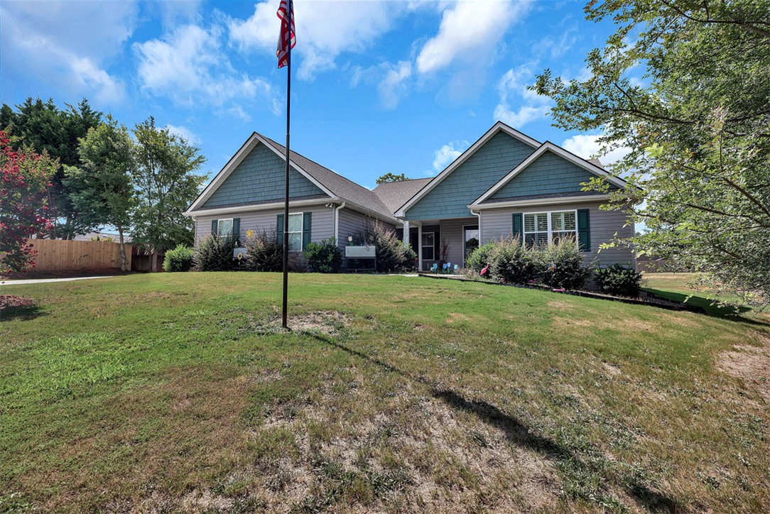 303 Plantation Point Anderson, SC 29625 - Photo 3 of 35 This charming home offers a welcoming facade with attractive landscaping and a lush green lawn.