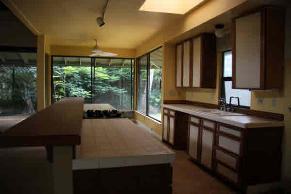 4332 Punee Road Koloa, HI 96756 - Photo 13 of 24 a kitchen with a table chairs sink and cabinets