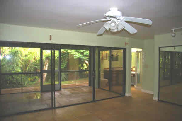 4332 Punee Road Koloa, HI 96756 - Photo 17 of 24 a view of a livingroom with a chandelier fan and windows
