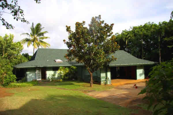 4332 Punee Road Koloa, HI 96756 - Photo 9 of 24 a front view of a house with a yard and garage