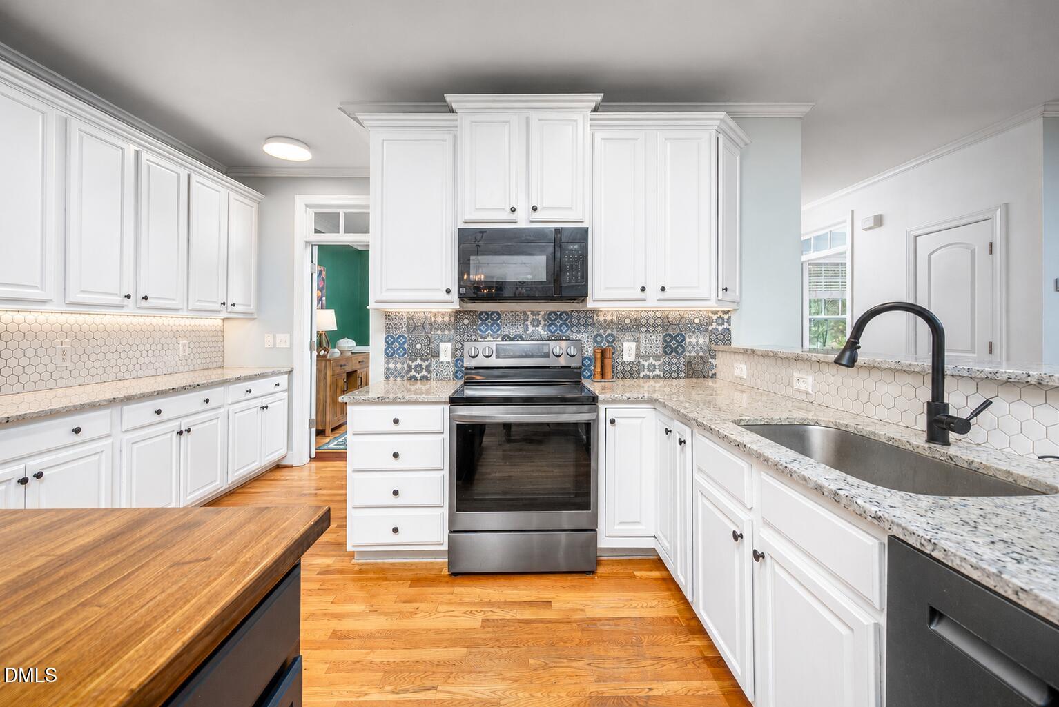 726 Ruth Circle Fuquay-Varina, NC 27526 - Photo 16 of 61 a kitchen with granite countertop a stove and a sink