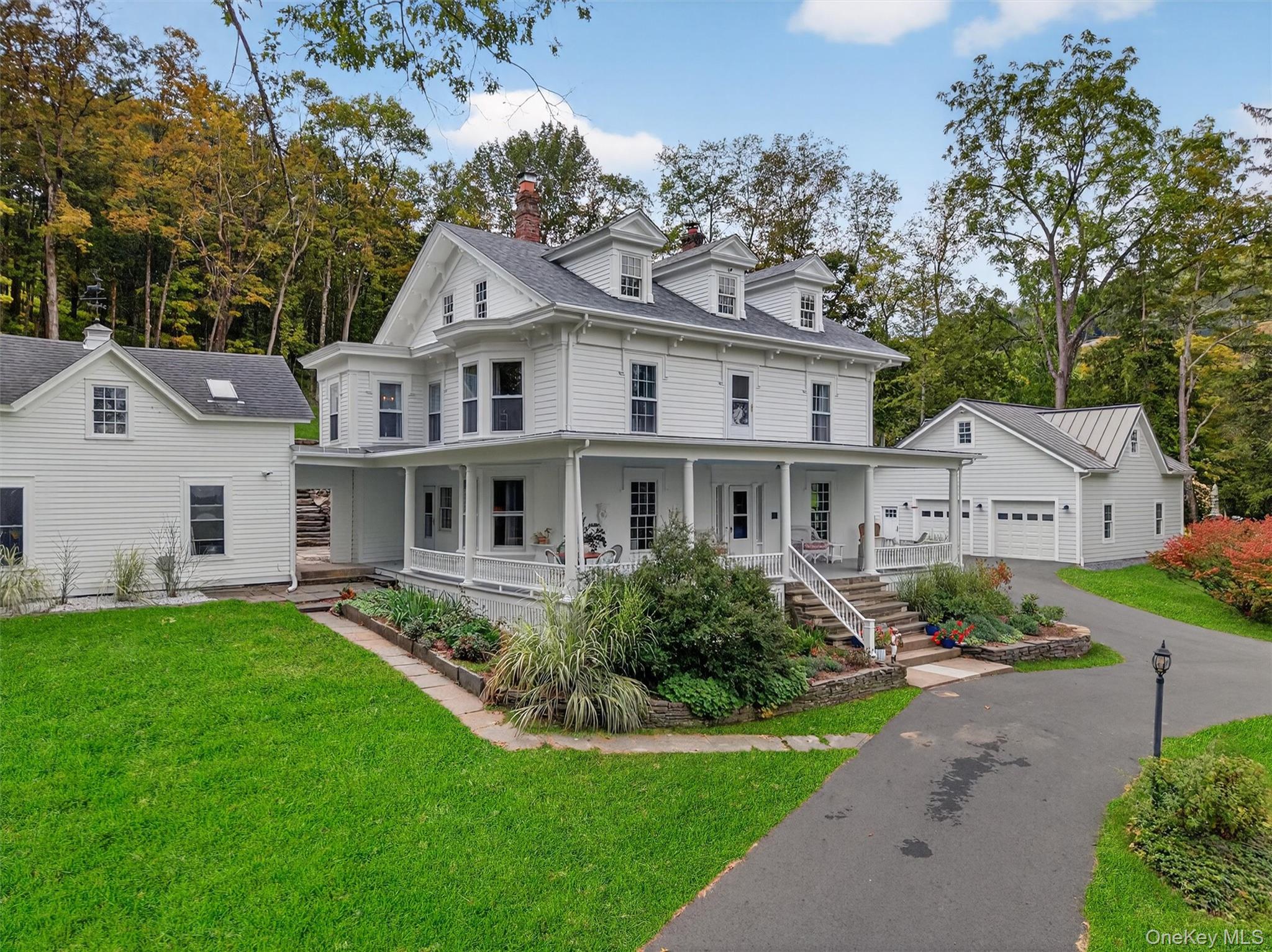 1657 River Road Damascus, PA 18415 - Photo 2 of 43 View of front of home featuring a garage, a chimney, covered porch, and a front lawn