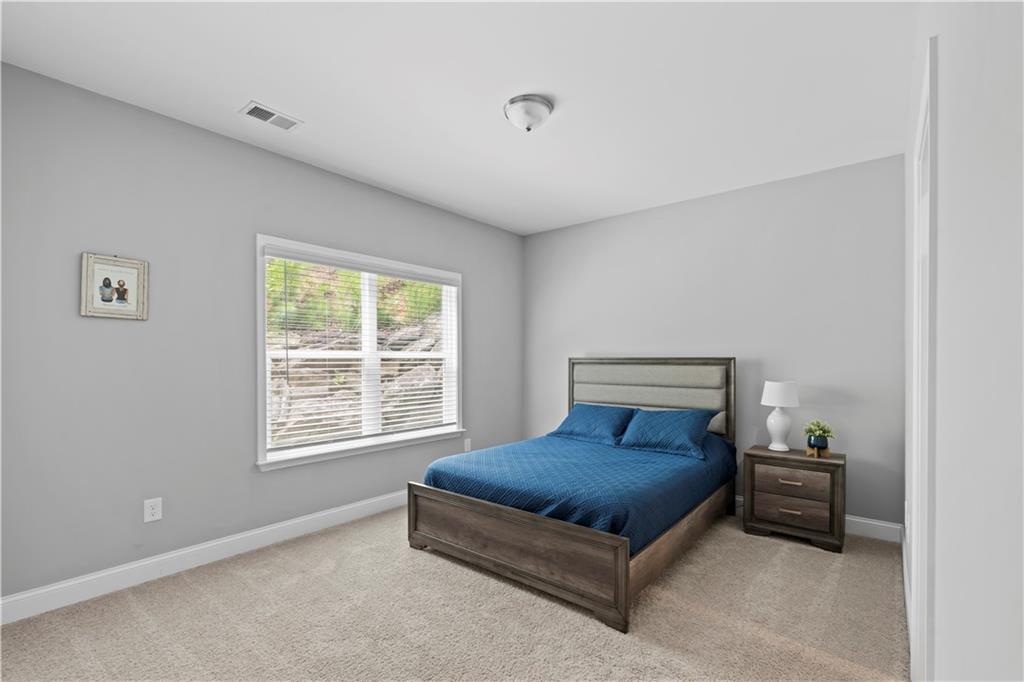 540 Glen Abbey Circle Mableton, GA 30126 - Photo 18 of 47 a bedroom with a bed and a window