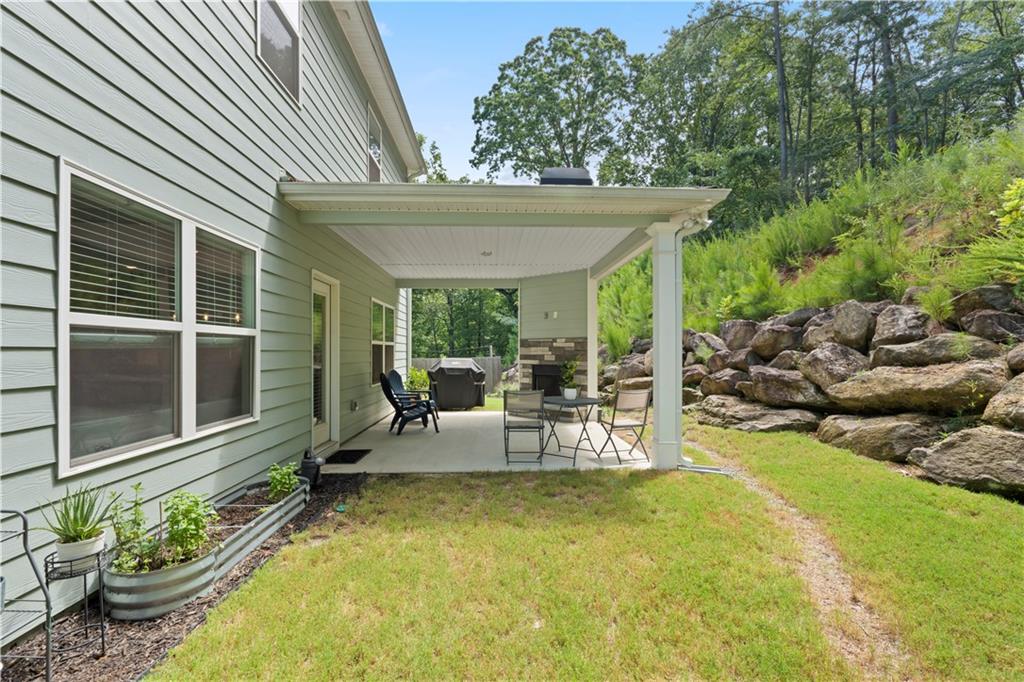 540 Glen Abbey Circle Mableton, GA 30126 - Photo 23 of 47 a view of a patio with chairs and potted plants