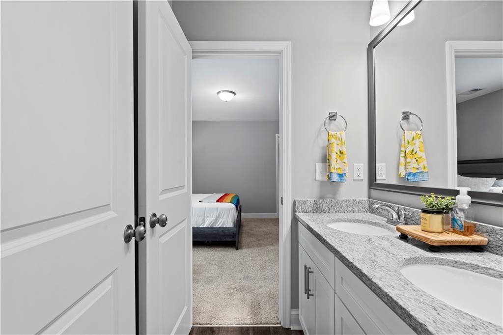 540 Glen Abbey Circle Mableton, GA 30126 - Photo 35 of 47 a en suite bathroom with a granite countertop sink and a mirror