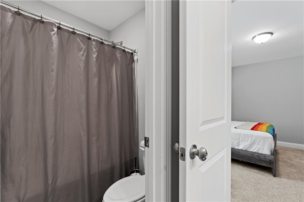 540 Glen Abbey Circle Mableton, GA 30126 - Photo 37 of 47 a bathroom with a sink and a shower curtain