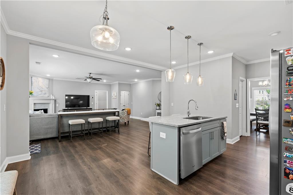 540 Glen Abbey Circle Mableton, GA 30126 - Photo 6 of 47 a large white kitchen with stainless steel appliances kitchen island a stove and a large countertops with wooden floor