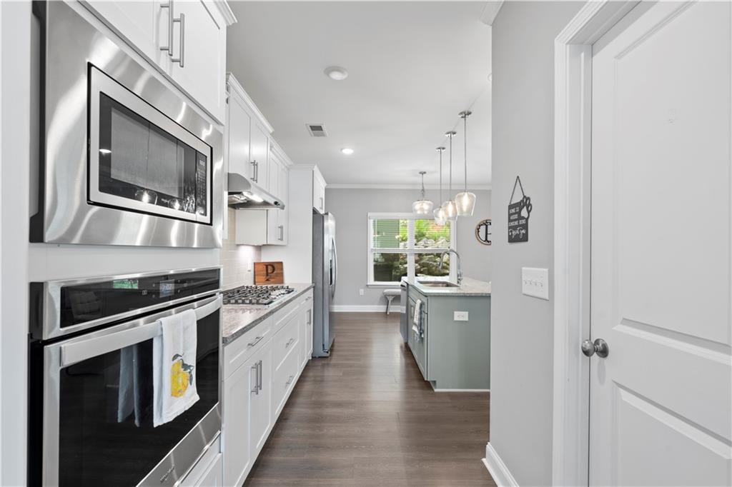 540 Glen Abbey Circle Mableton, GA 30126 - Photo 10 of 47 a kitchen with stainless steel appliances a stove microwave and sink