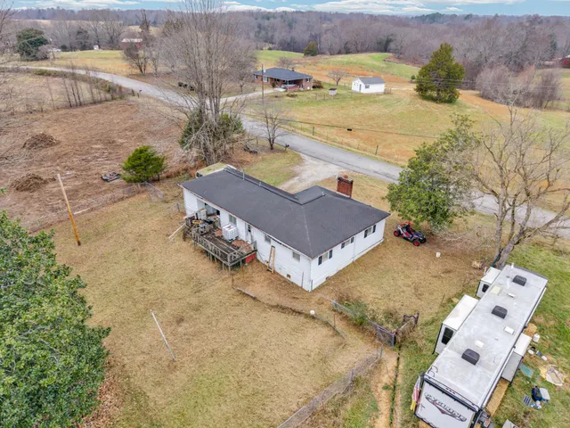 an aerial view of a house with outdoor space