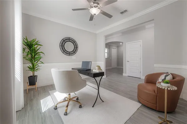 a living room with furniture and a potted plant