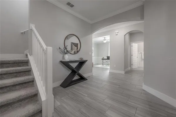 a view of a hallway with wooden floor and entryway