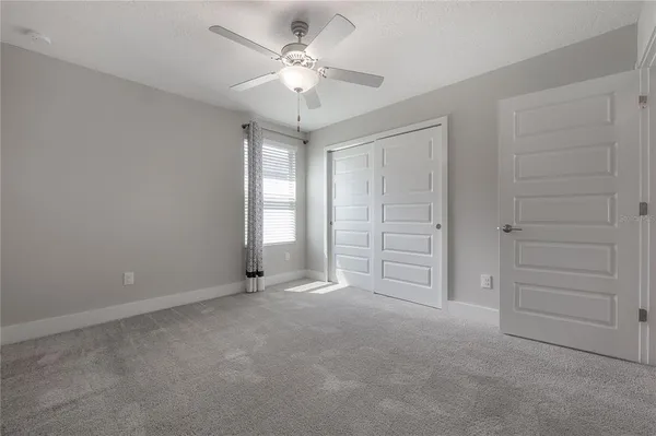 an empty room with a ceiling fan
