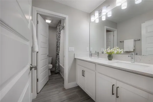 a bathroom with a double vanity sink and mirror