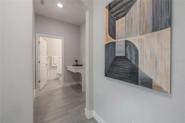 a view of a hallway view with wooden floor and staircase