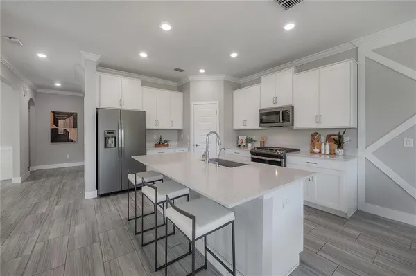 a kitchen with stainless steel appliances a refrigerator stove microwave and cabinets