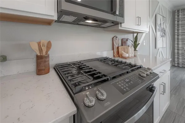 a stove top oven sitting inside of a kitchen