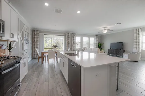 a kitchen with sink stove and cabinets
