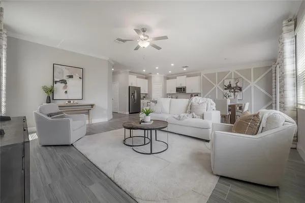 a living room with furniture and kitchen view