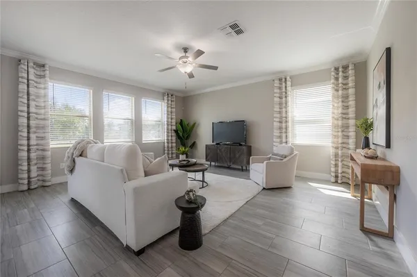 a living room with furniture and a large window