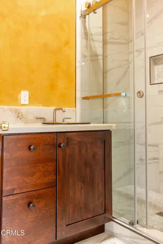 a bathroom with a shower and a sink