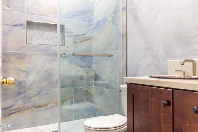 a bathroom with a shower and toilet