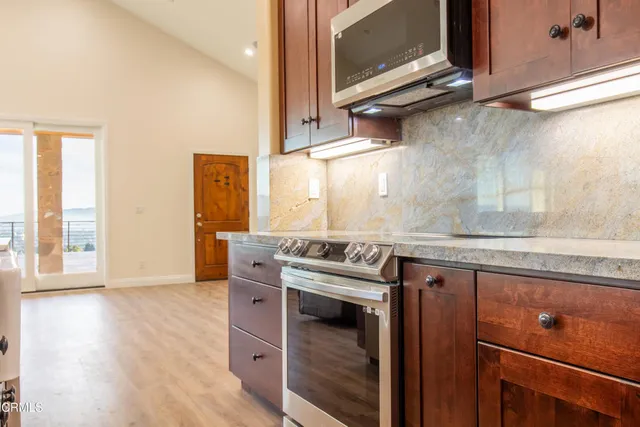 a kitchen with granite countertop a stove and a sink