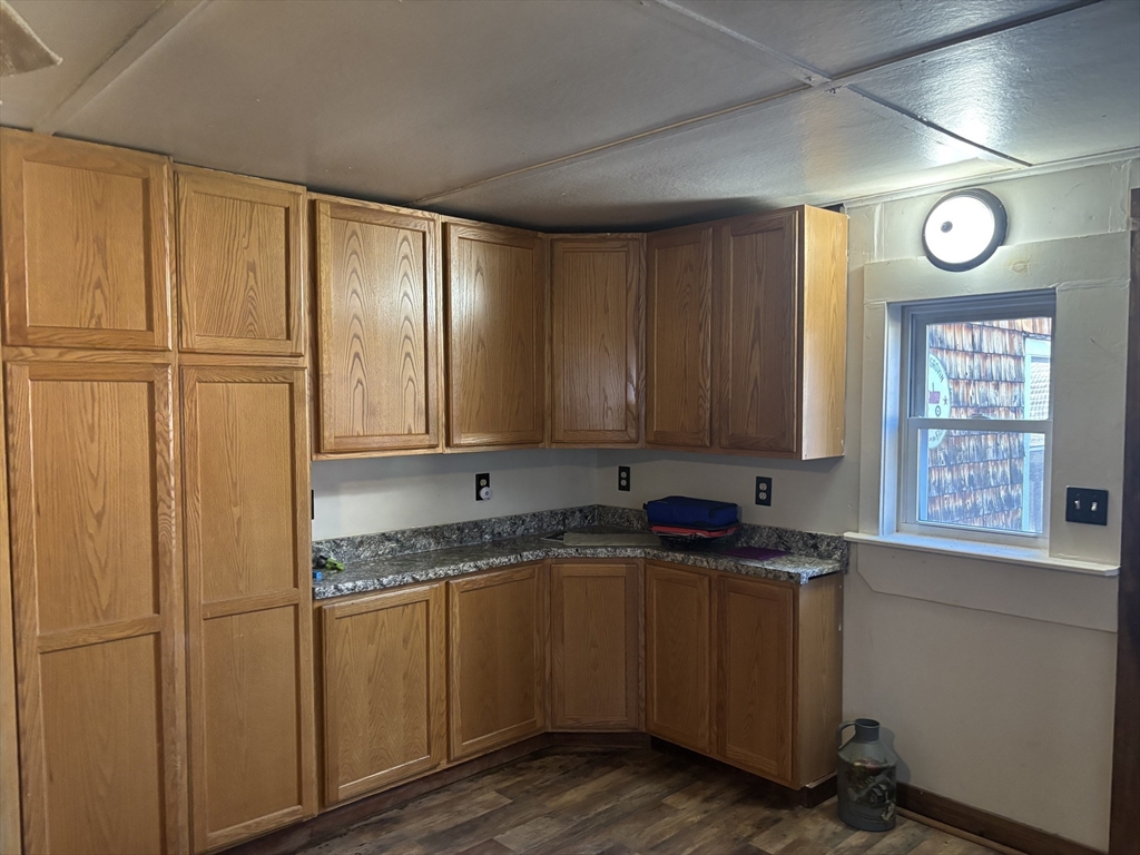 10 Cottage Street Belchertown, MA 01007 - Photo 25 of 40 a kitchen with granite countertop cabinets stainless steel appliances and a window