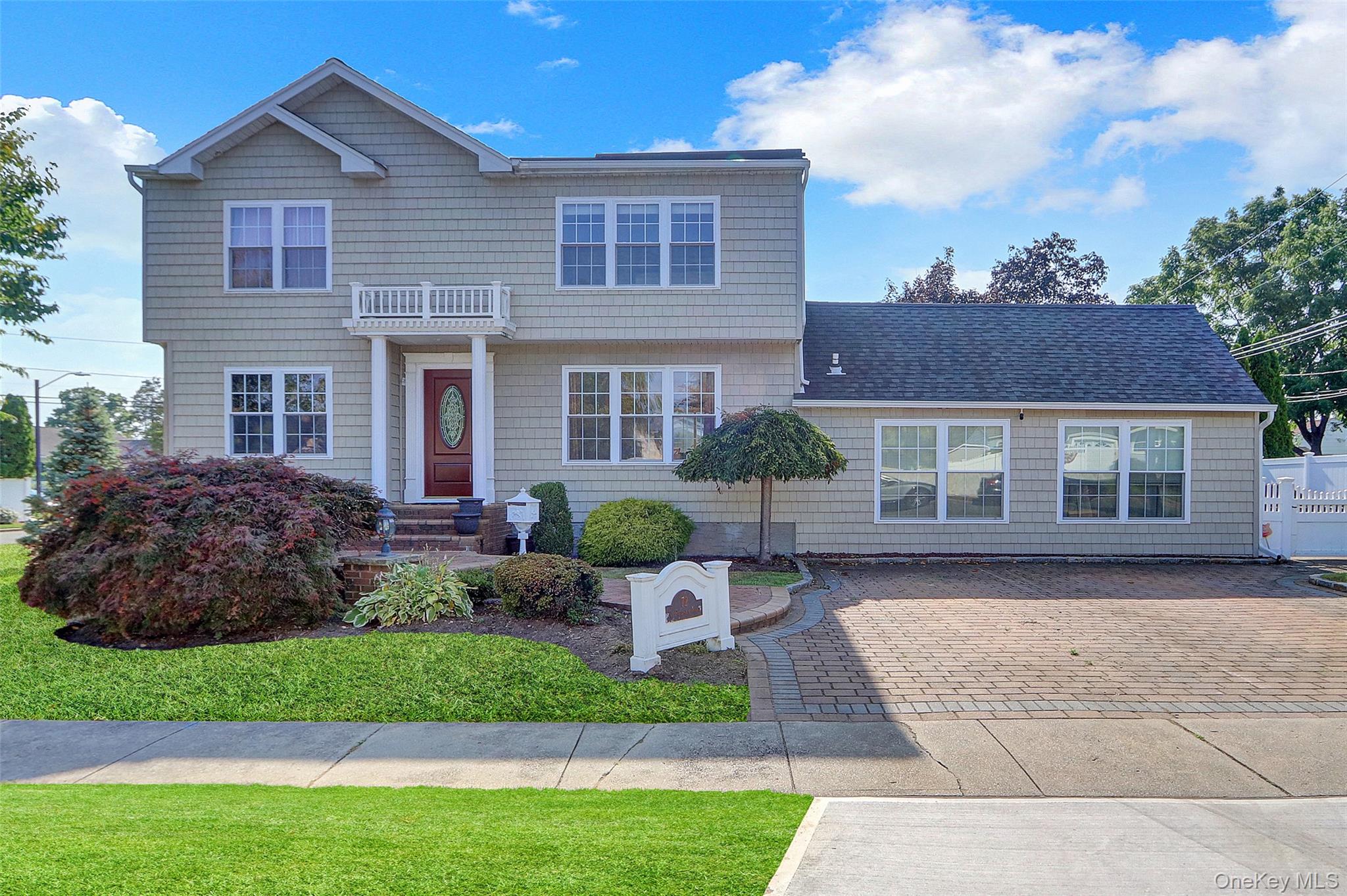 a front view of a house with a garden and plants