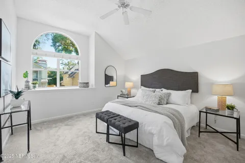 a bedroom with a bed and a window