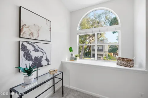 a view of a door with a painting on the wall