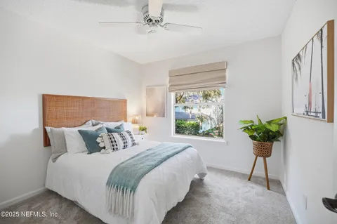 a bedroom with a bed and a potted plant