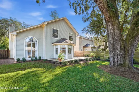 a view of a house with a yard and sitting area