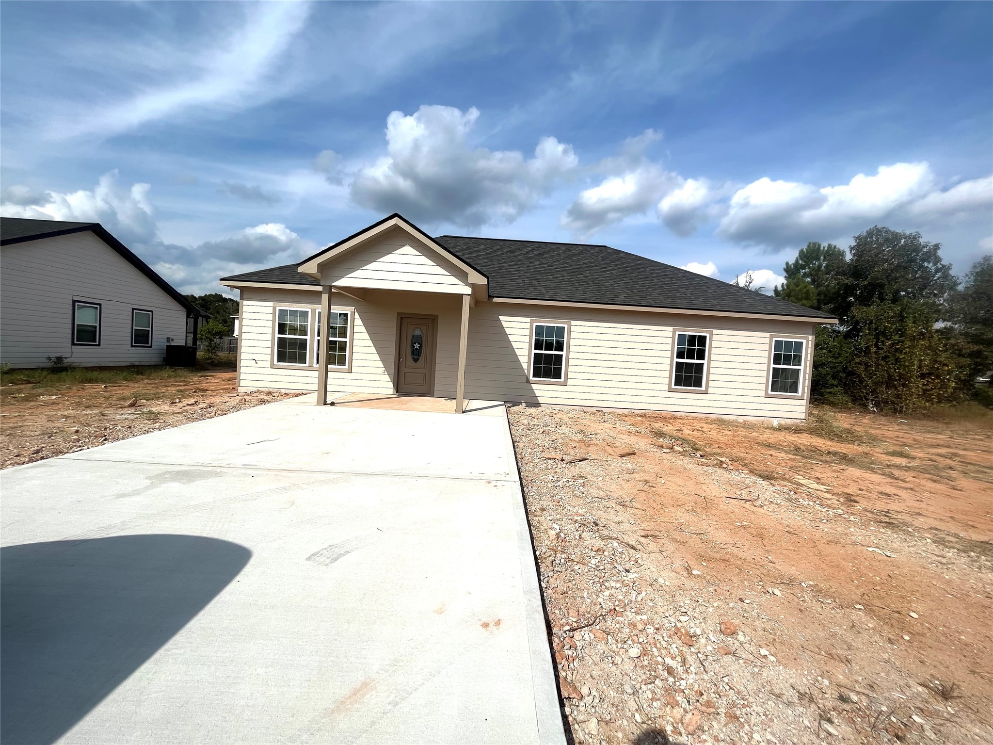 a view of a house with a backyard