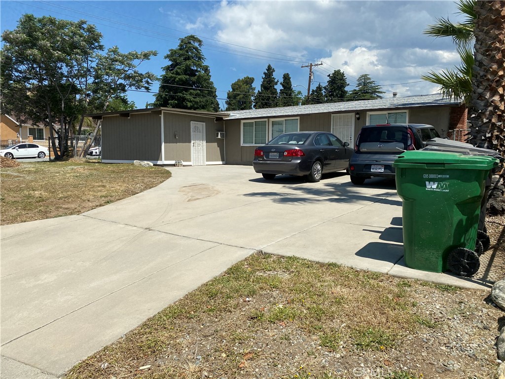 a view of a house with a patio and a yard