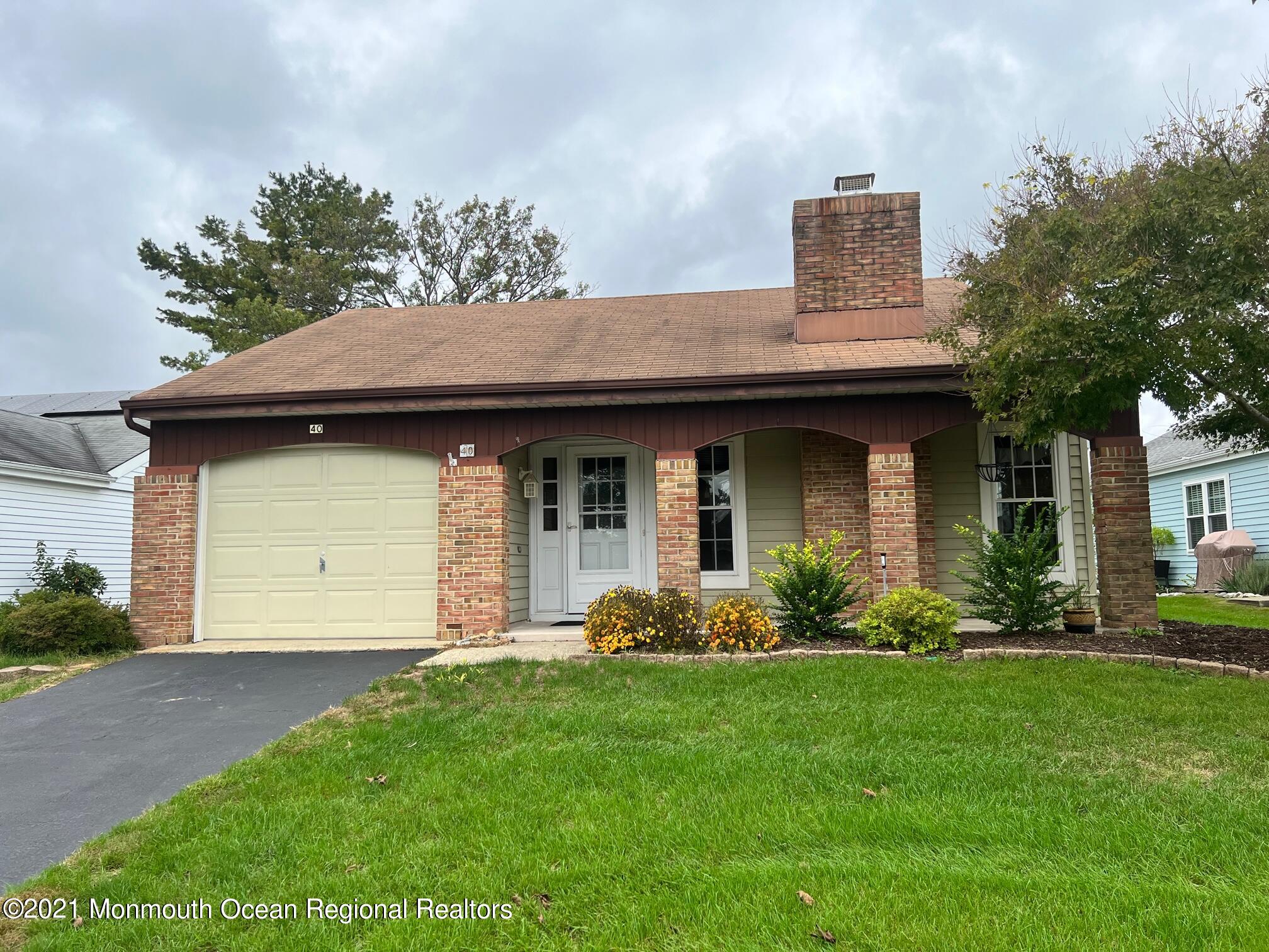 40 Red Hill Road Manchester Township, NJ 08759 - Photo 1 of 33 a front view of a house with a garden and plants