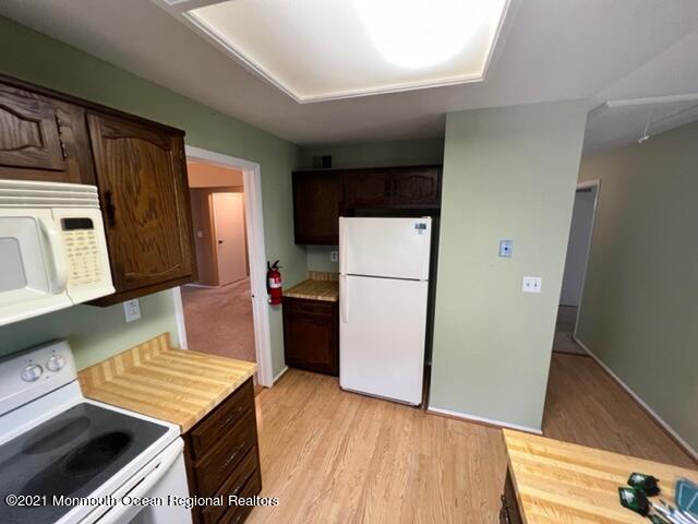 40 Red Hill Road Manchester Township, NJ 08759 - Photo 12 of 33 a kitchen with a refrigerator and a stove top oven