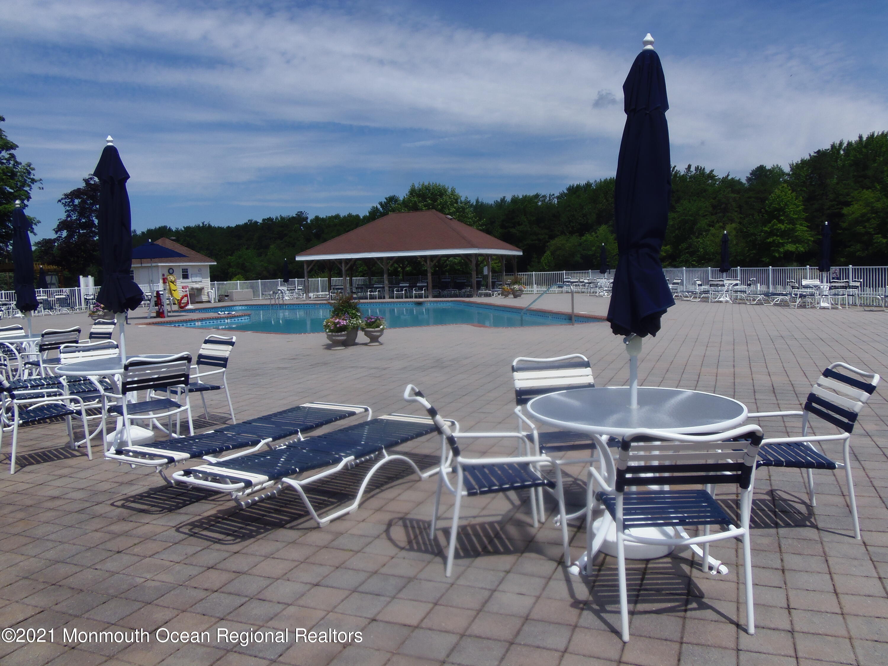 40 Red Hill Road Manchester Township, NJ 08759 - Photo 32 of 33 a view of a patio with a table chairs and a fire pit