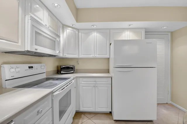 a view of a lake with houses in the back