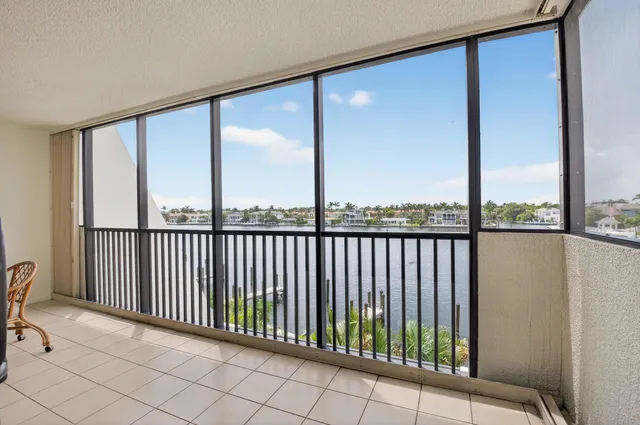 a view of a tennis ground with tall buildings