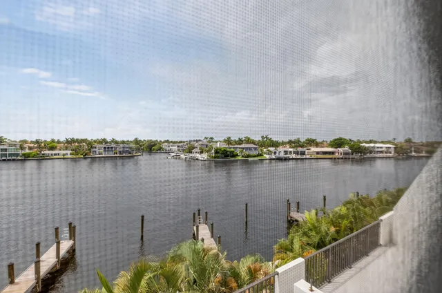 a view of the patio with a table and chairs under an umbrella