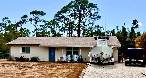 a front view of a house with cars parked