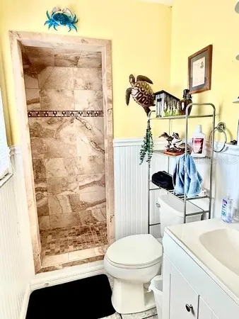 a bathroom with a sink toilet and shower