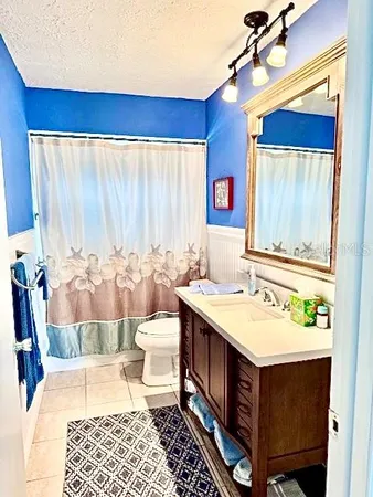 a bathroom with a sink a toilet and mirror