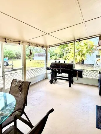 a living room with furniture floor to ceiling window and outdoor view