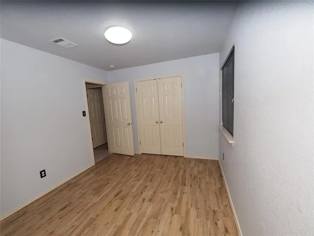 a view of hallway with wooden floor