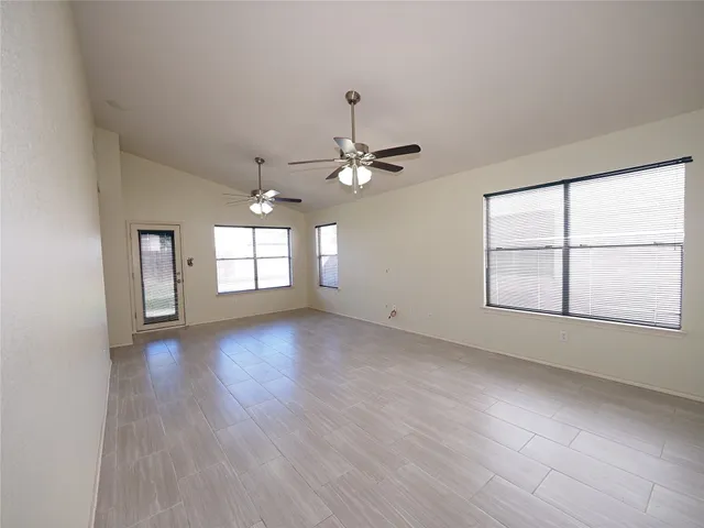 a kitchen with stainless steel appliances granite countertop wooden cabinets a stove a sink and a window