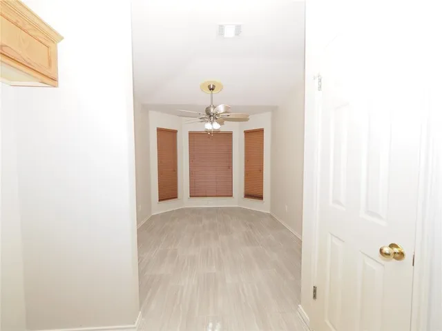 a view of a hallway with chandelier and entryway