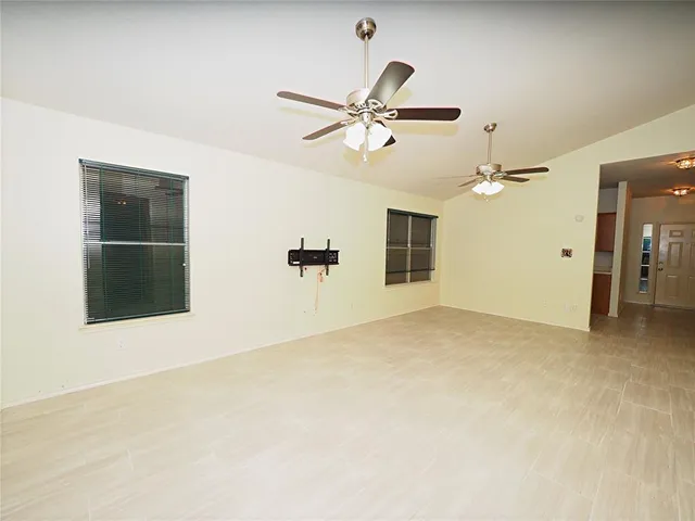 an empty room with closet and windows